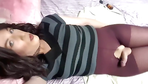 Shemale with stockings enjoys a masturbation video